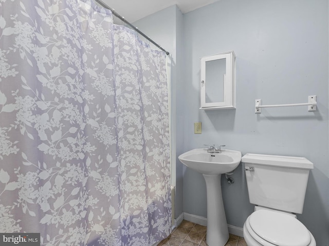 bathroom with toilet, tile patterned floors, and a shower with shower curtain