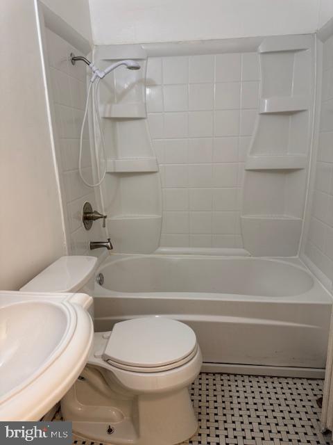 full bathroom featuring toilet, sink, and shower / tub combination