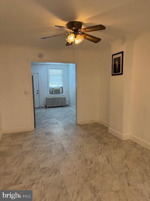 unfurnished room with ceiling fan, cooling unit, and radiator