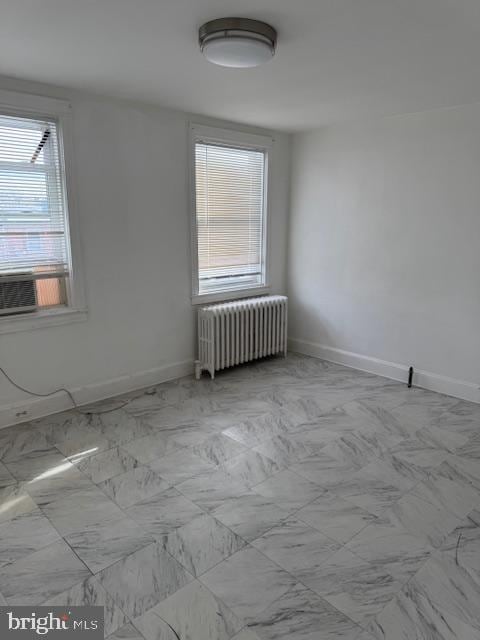 unfurnished room with radiator and cooling unit