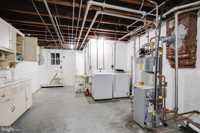 basement featuring water heater and separate washer and dryer