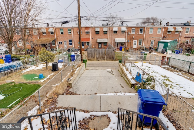 yard layered in snow featuring central AC unit