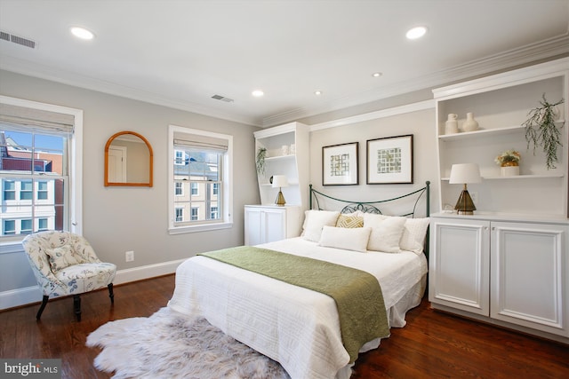 bedroom with ornamental molding and dark hardwood / wood-style floors