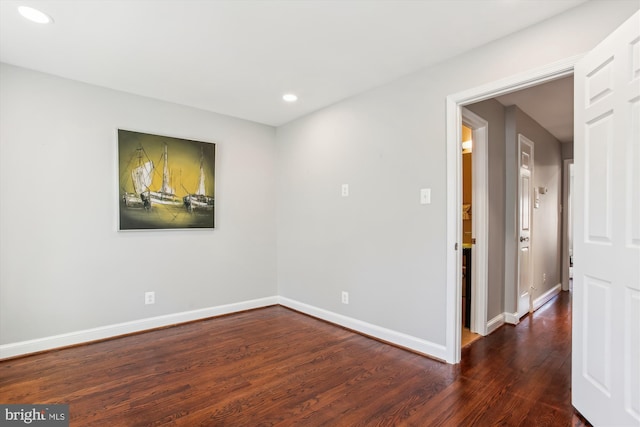 empty room with dark wood-type flooring