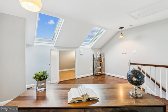 home office with hardwood / wood-style flooring and vaulted ceiling with skylight