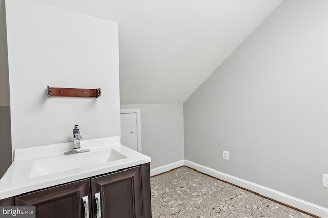 bathroom featuring sink and vaulted ceiling