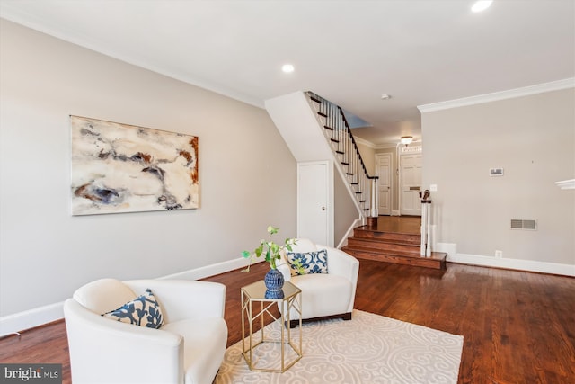 sitting room with crown molding and wood-type flooring