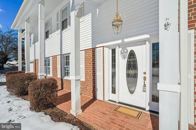 view of snow covered property entrance