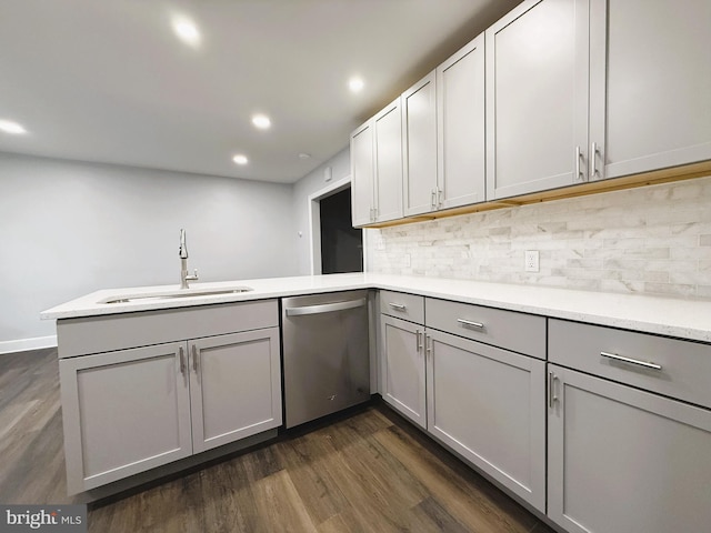 kitchen featuring gray cabinetry, dishwasher, kitchen peninsula, and sink