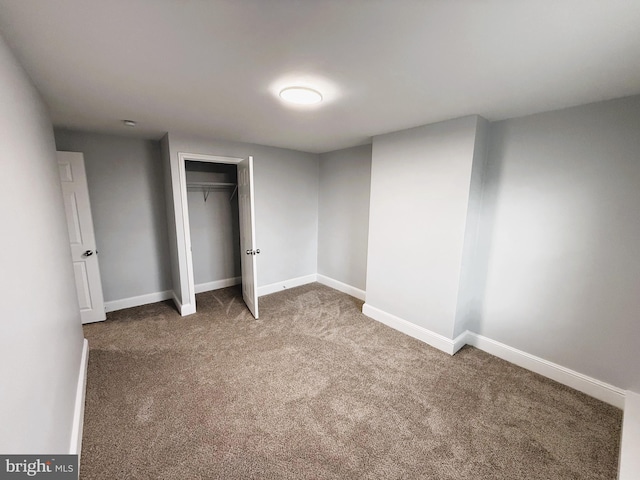 unfurnished bedroom featuring a closet and carpet