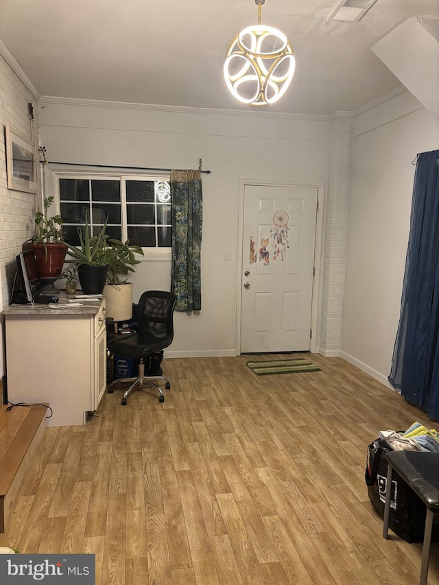 office with ornamental molding, light hardwood / wood-style floors, and brick wall