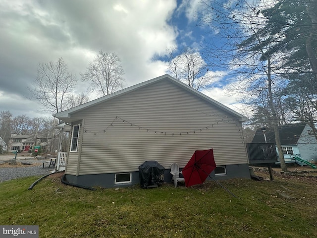 view of side of property with a lawn