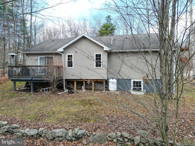 back of house featuring a wooden deck