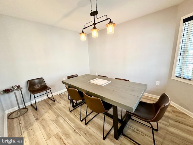 dining area with light hardwood / wood-style flooring