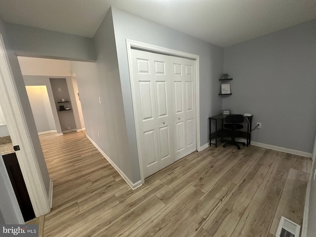 hall with light hardwood / wood-style floors