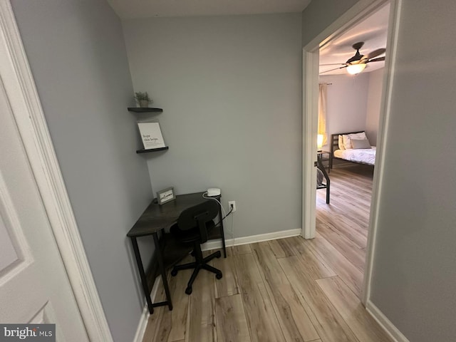 office with ceiling fan and light hardwood / wood-style floors