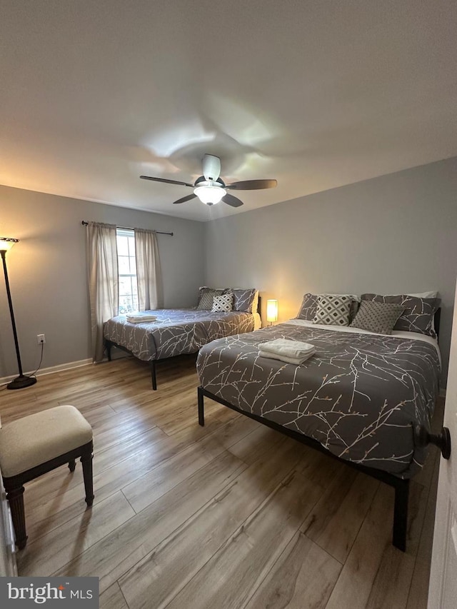 bedroom featuring ceiling fan and light hardwood / wood-style floors