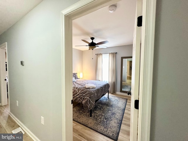 bedroom with ceiling fan and light wood-type flooring