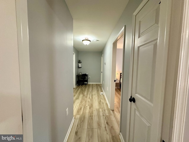 corridor with light wood-type flooring