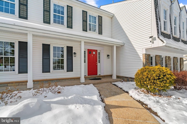 view of snow covered property entrance