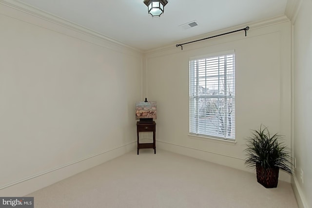 carpeted empty room with crown molding