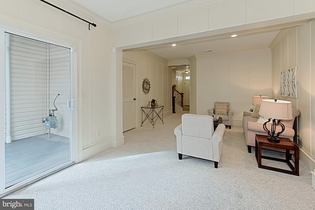 living area with carpet flooring and crown molding