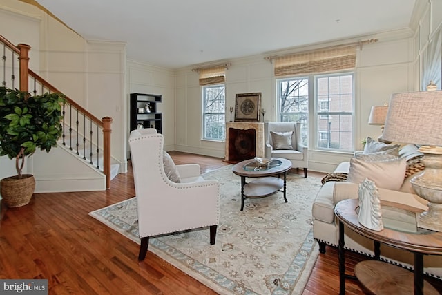 living room featuring light wood-type flooring and ornamental molding