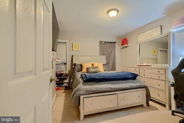 bedroom with cooling unit and light carpet