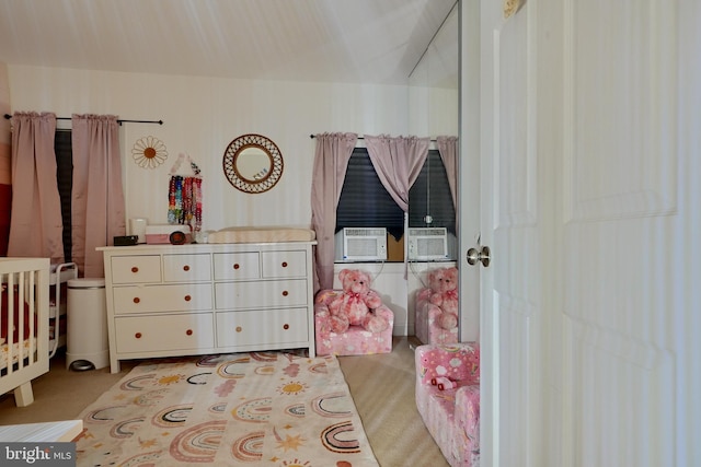 bedroom featuring cooling unit and a nursery area