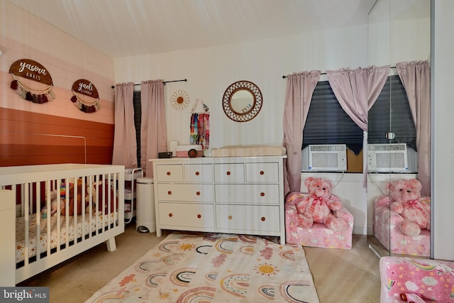 carpeted bedroom with cooling unit and a nursery area