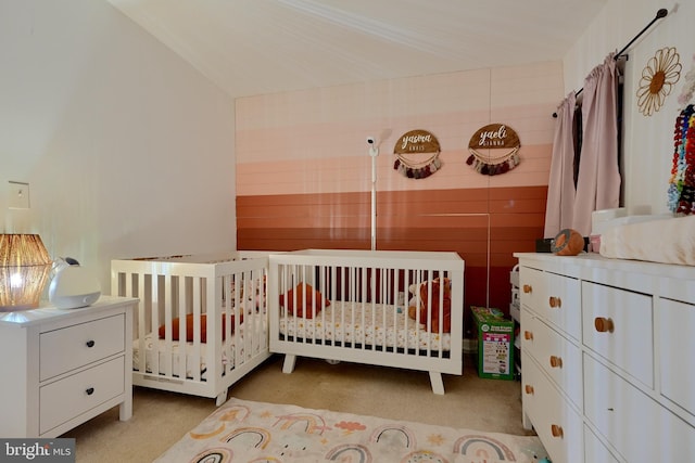 bedroom with light carpet and a crib