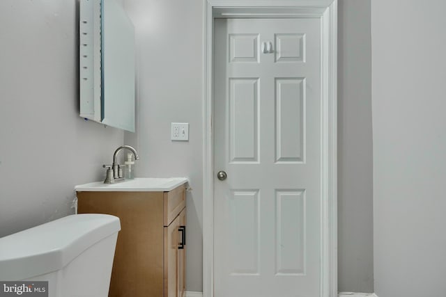 bathroom featuring toilet and vanity