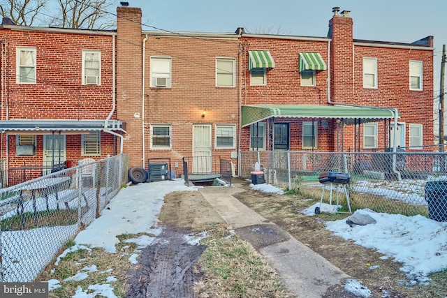 view of snow covered rear of property