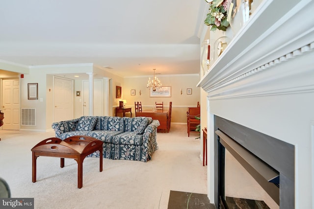 living room with ornamental molding, a notable chandelier, light carpet, and ornate columns