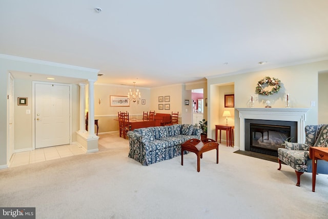 carpeted living room featuring an inviting chandelier, crown molding, and decorative columns