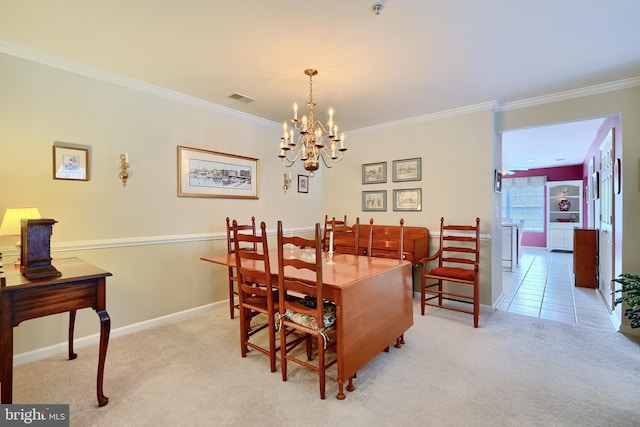 dining space with light colored carpet, an inviting chandelier, and crown molding