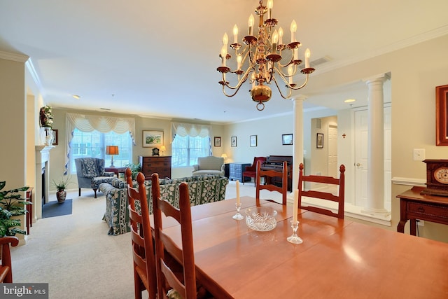 dining room with decorative columns, an inviting chandelier, light colored carpet, and ornamental molding