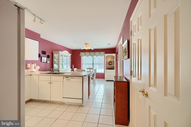 kitchen featuring sink, white cabinets, dishwasher, ceiling fan, and kitchen peninsula