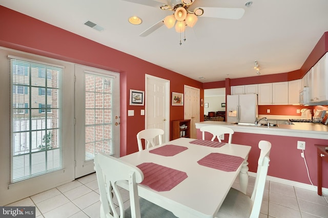 dining area with ceiling fan and light tile patterned floors