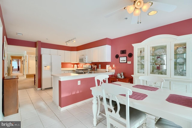 kitchen featuring white cabinets, white appliances, ceiling fan, light tile patterned floors, and track lighting