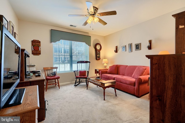 carpeted living room featuring ceiling fan