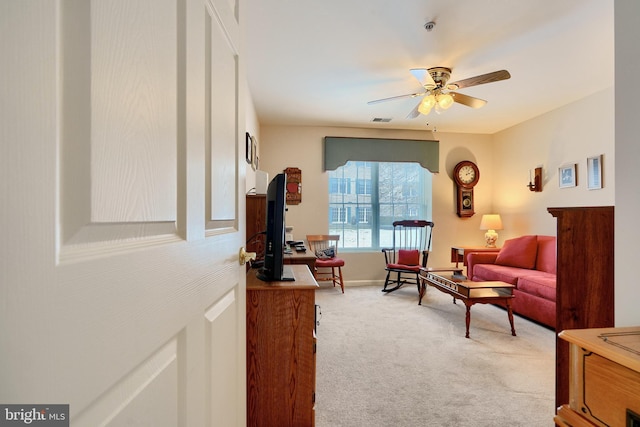 carpeted living room with ceiling fan