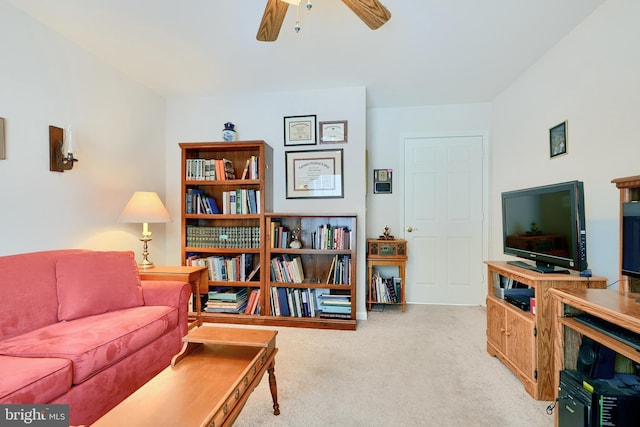 carpeted living room featuring ceiling fan