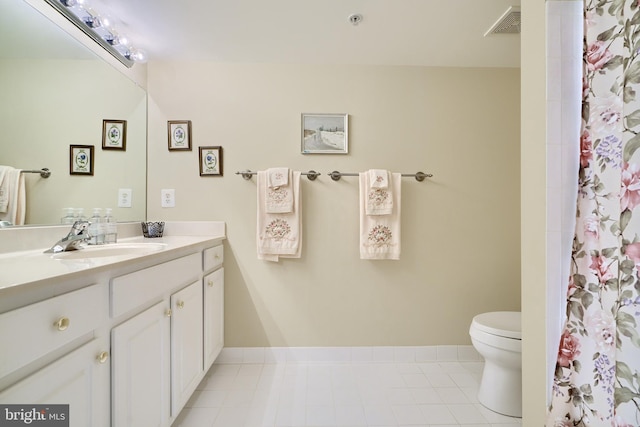 bathroom with a shower with curtain, tile patterned floors, vanity, and toilet