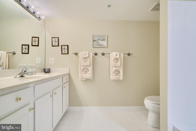 bathroom featuring vanity, tile patterned flooring, and toilet