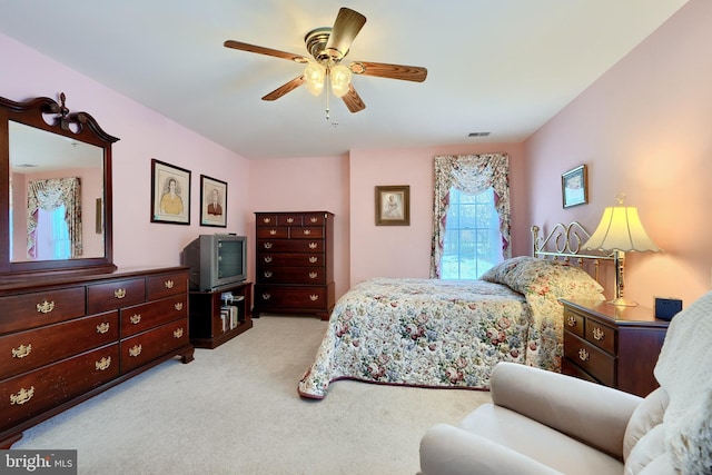 bedroom with ceiling fan and light colored carpet