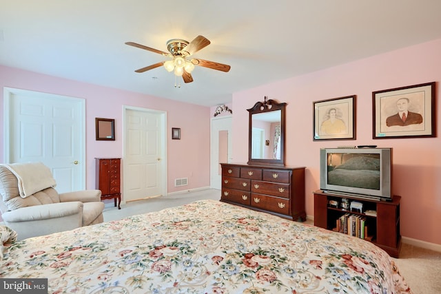 bedroom featuring ceiling fan and light carpet