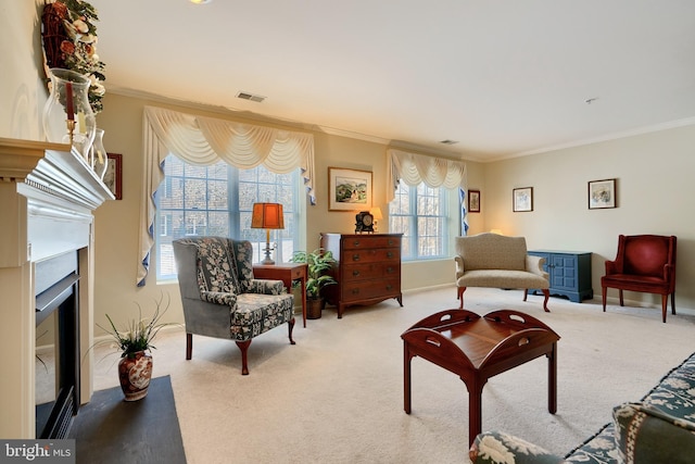 living area with crown molding and light colored carpet