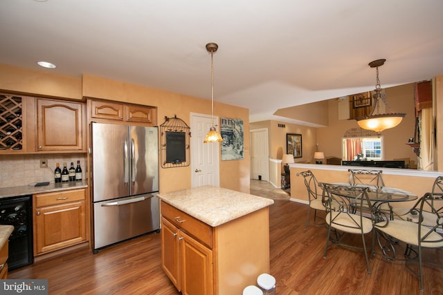 kitchen with a kitchen island, stainless steel built in refrigerator, wine cooler, tasteful backsplash, and hanging light fixtures