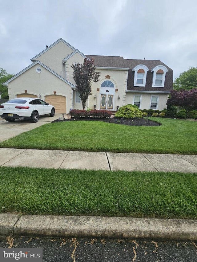 view of front of property with a garage and a front yard